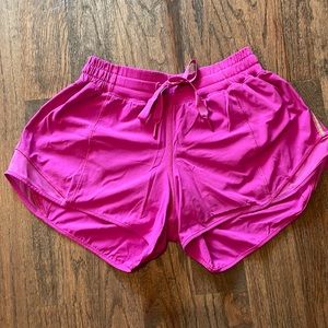 Lululemon Hotty Hot Low Rise Lined 4” short with silver stripe on the sides
